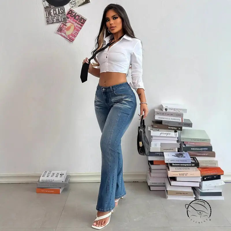 Woman in white crop top and casual slimming denim trousers with handbag