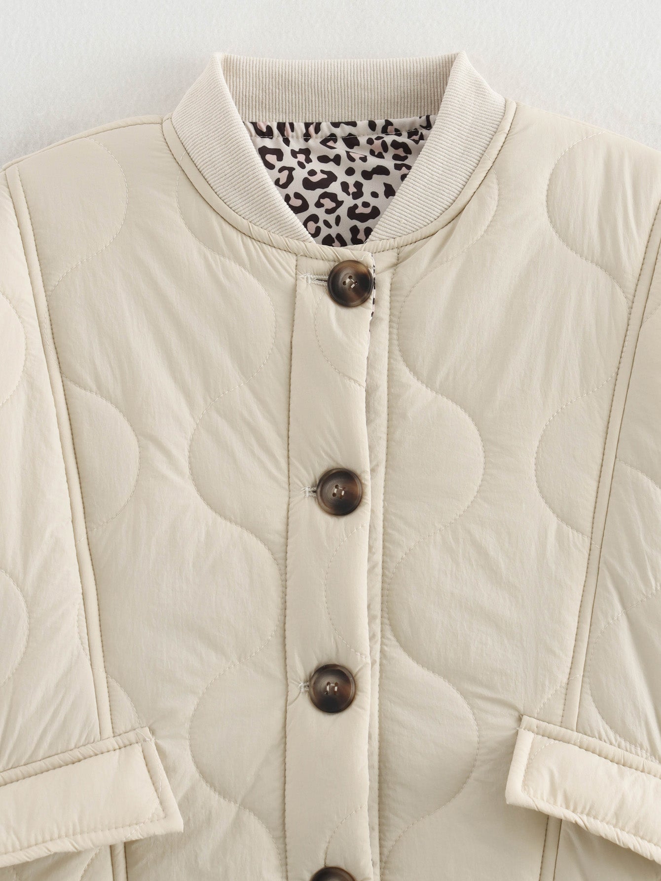 Beige quilted jacket with animal print lining, a stylish langry fashion ملابس piece