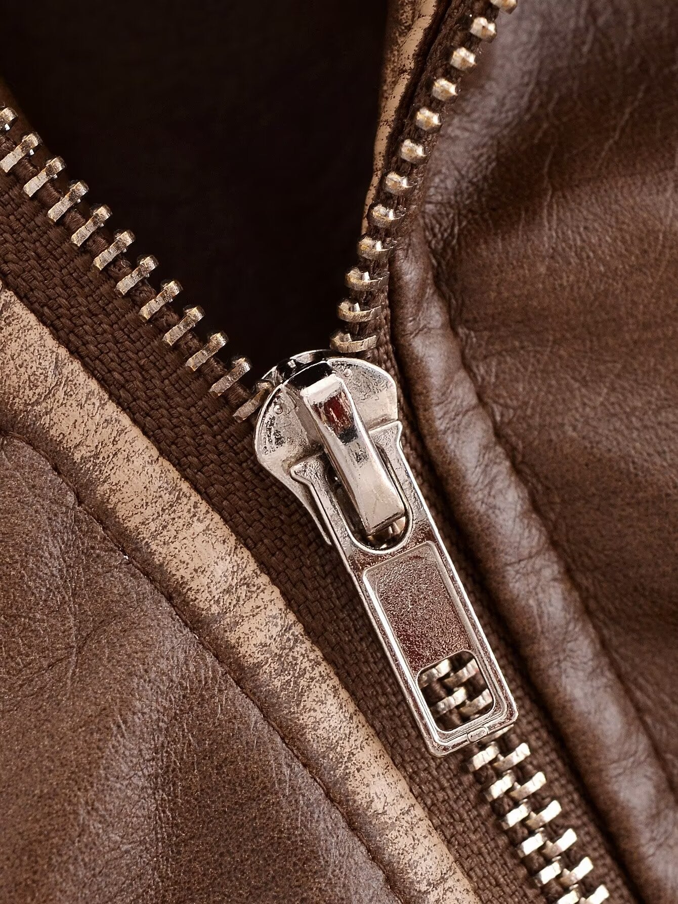 Faux leather motorcycle jacket zipper with silver teeth and metal slider