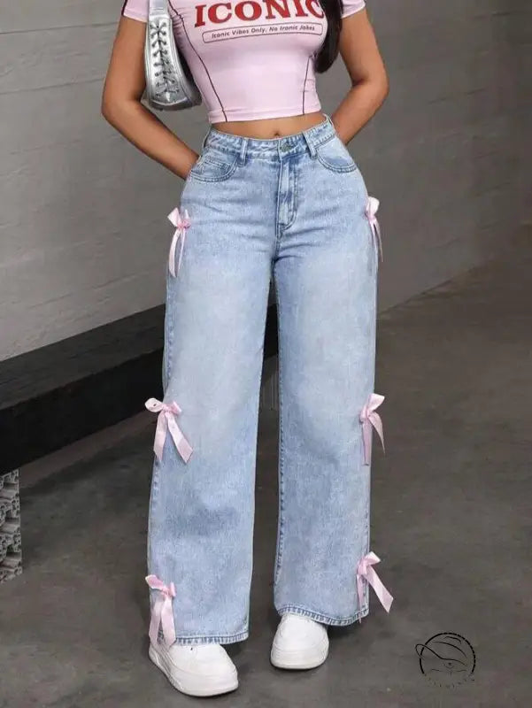 Light wash loose straight leg jeans with pink bow accents
