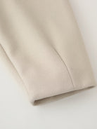 Beige satin blouse with pleated sleeve hem in Langry single breasted jacket