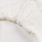 White lace floral fabric with frayed edges in Langry fashion dress