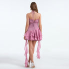 Back view of a pink halter dress showcasing elegant design in fashion ملابس