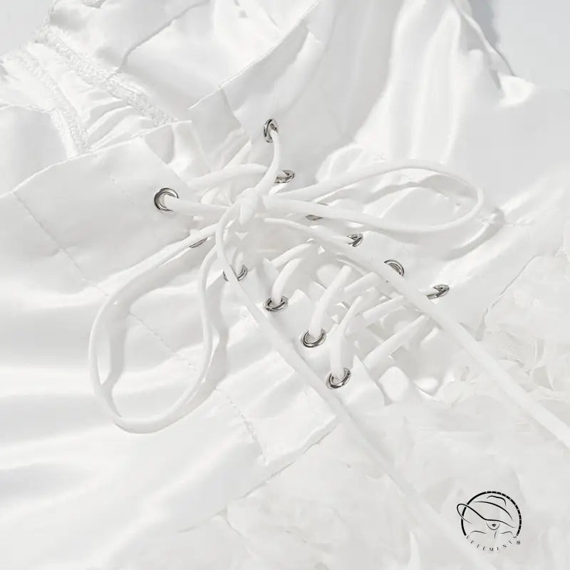 White lace-up boot with silver eyelets on early spring floral dress