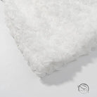 White fluffy bath mat with early spring floral three dimensional texture