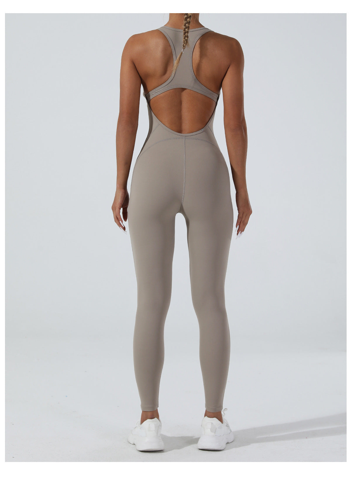 Sleek taupe langry yoga one-piece jumpsuit with racerback and open back