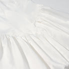 Elegant white cotton fashion dress with ruffled neckline, fitted waist bowknot, lace up sleeves