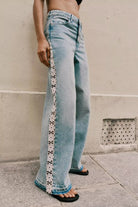 Light blue wide leg jeans with white floral embroidery and high waist