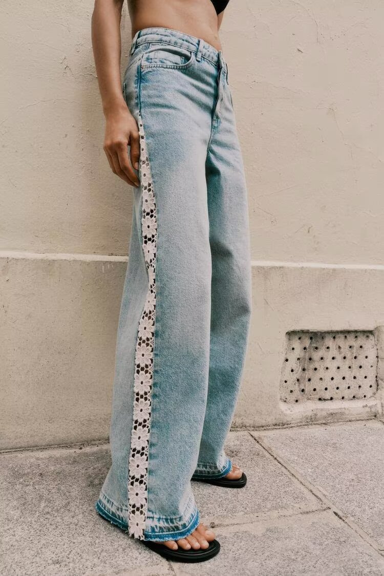 Light blue wide leg jeans with white floral embroidery and high waist