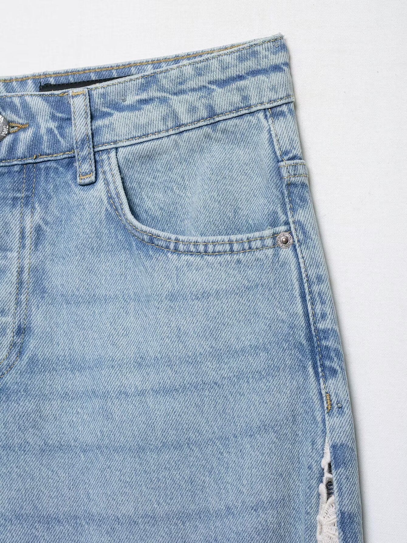 Light blue wide leg denim jeans with crochet stitching and distressed details