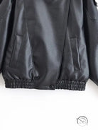 Retro faux leather jacket with bomber style, elastic hem and pockets