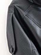 Retro faux leather jacket with textured surface and snap closure