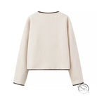 Cozy lace cream-colored cropped sweater with black trim