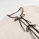 Cozy Lace up Coat with cream drawstring bag in langry fashion