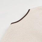 Cream-colored felt hat with brown trim for Langry fashion coats