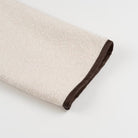 Beige and brown textured towel with dark trim in Langry cozy fashion coat