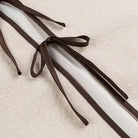 Brown leather shoelaces with bow tie design on Langry fashion coat