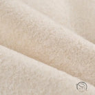 Cozy lace up coat with cream-colored plush fuzzy blanket texture
