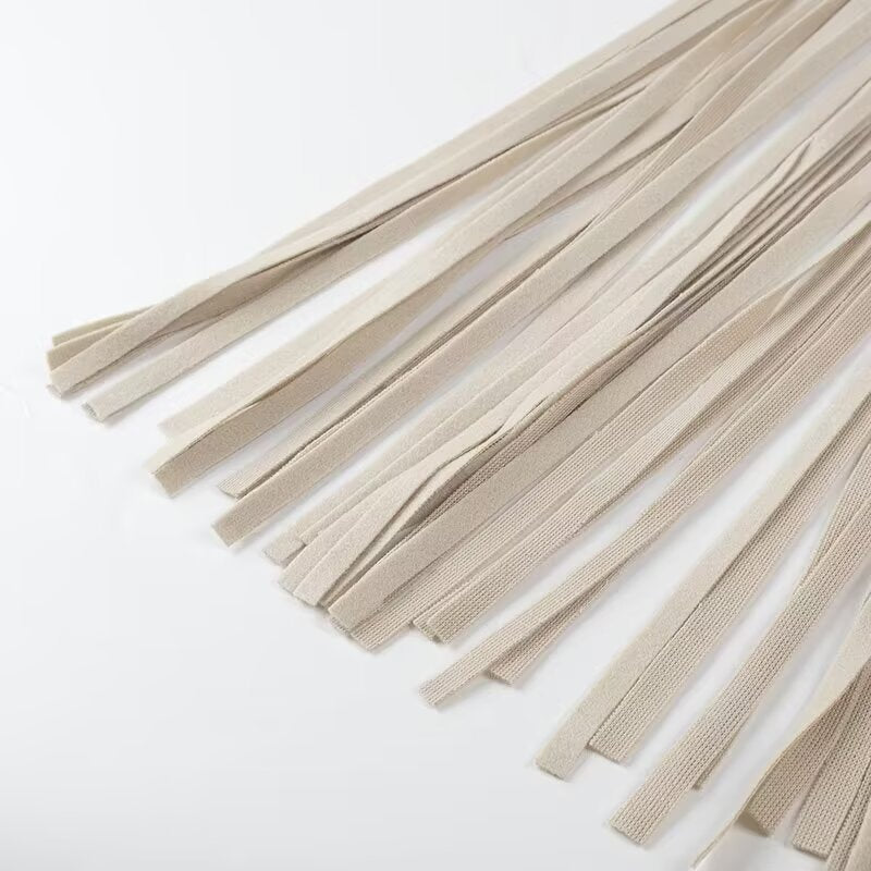 Beige woven cord tassel necklace with silver accents on Langry fashion trench coat