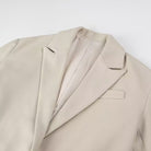 Langry fashion beige wool suit jacket with lapels, pockets, and tassel details