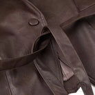 Fashionable faux leather jacket with button closure and belt detail
