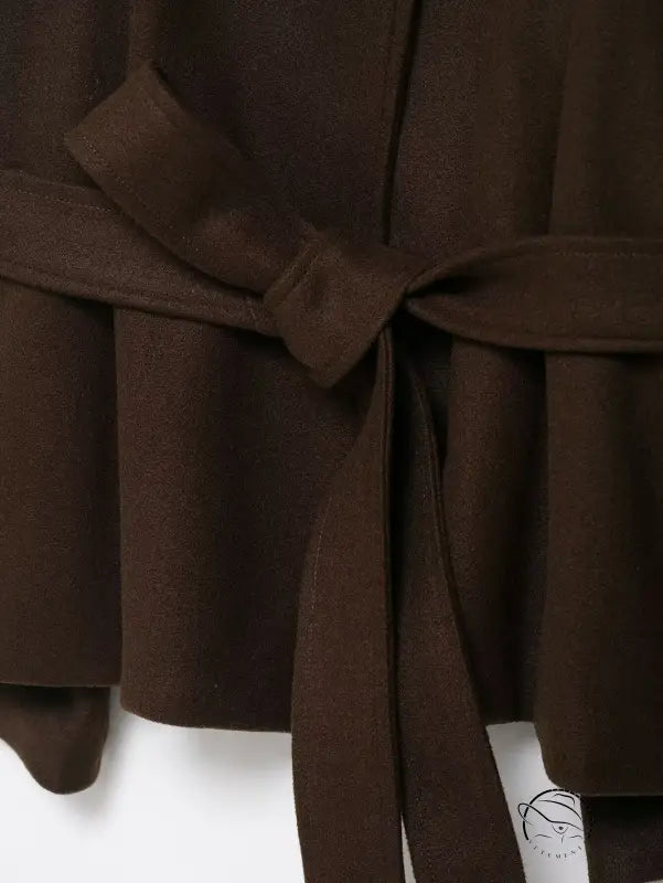 Brown pleated skirt with bow belt on woolen cape coat