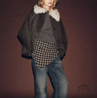 Fur effect neckline coat with black fur trim, plaid shirt, and blue jeans