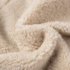 Cream-colored sherpa blanket in Langry fashion furry coat with polo collar