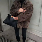 Casual Langry big fur terry coat in brown with black leather handbag and red tag