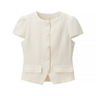 Cream textured short sleeve bud cardigan with button closure and pocket detail