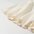 Cream ruffled skirt with textured weave in Enchanting Short Sleeve Bud Top suit