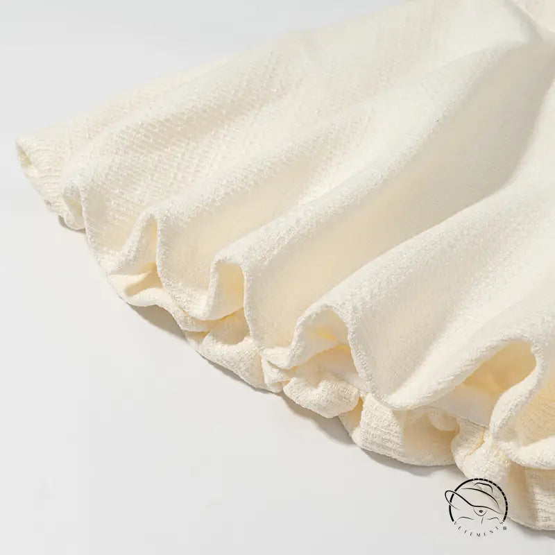 Enchanting short sleeve bud top with cream ruffled fabric skirt