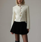 Langry fashion cream textured cropped jacket with white buttons and black skirt