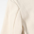 Cream-colored ribbed langry fashion sweater in classic short coat style