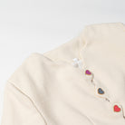 Langry cream cardigan coat with colorful heart buttons and metallic accents