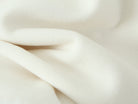Elegant white silk scarf with soft folds on Langry fashion woolen jacket