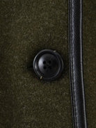 Black button with four holes on textured fabric, Langry fashion coat detail