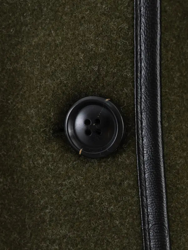 Black button with four holes on textured fabric for Langry fashion woolen coat