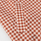 Casual plaid trench coat in red white gingham fabric with pocket detail