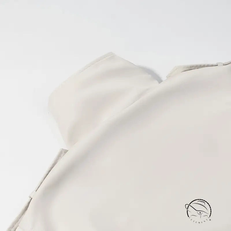 Cream-colored silk blouse in windbreaker winter fashion style