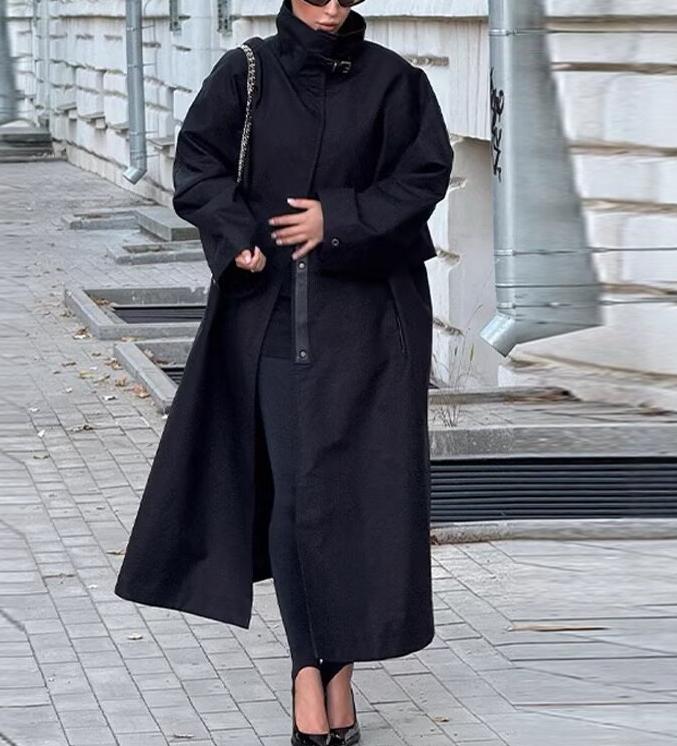 Fashionable black long trench coat with oversized sleeves and zipper details