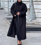 Fashionable black long trench coat with oversized sleeves and zipper details