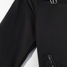 Fashionable black leather trench coat with silver zipper details