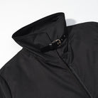 Fashionable black langry trench coat with high collar, zipper, and belt loops