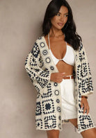 Woman in cream navy crochet cardigan with geometric patterns, long sleeved fashion top