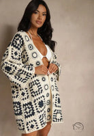 Cream and navy blue crocheted long-sleeved cardigan with geometric pattern
