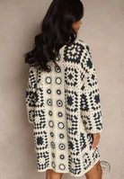 Cozy off-white navy crochet coat with geometric patchwork, long sleeved fashion top
