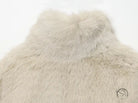 Cream faux fur vest in fur effect short coat with high collar and textured surface