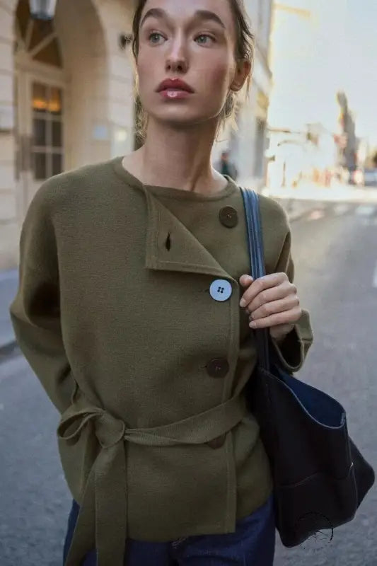 Olive green wool coat with regular sleeve, button detail, and Langry blue strap bag