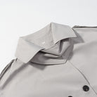 Light gray langry fashion trench coat with double-breasted buttons and black trim